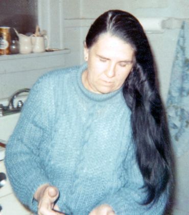 Inez Running-rabbit with long black hair.