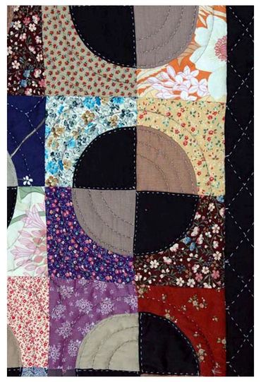 Close up again of handmade quilt by Inez Running-Rabbit.