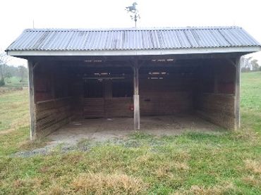 Run-in shed with mats and back storage area.