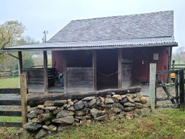 Outside stalls on modified corn crib barn.