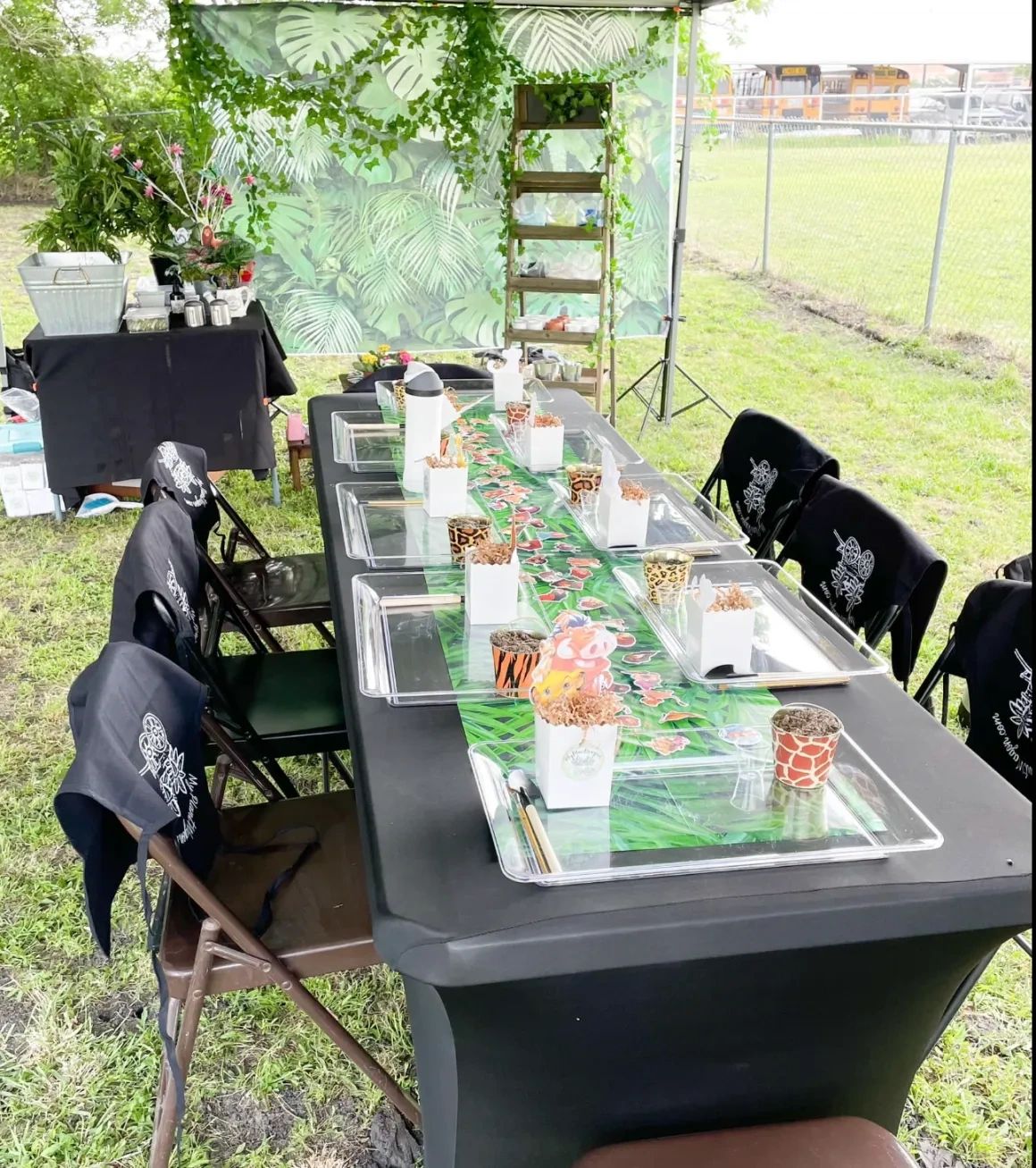 Outdoor My Plant Wagon Plant Bar setup with planters, supplies and a table prepared for guests.