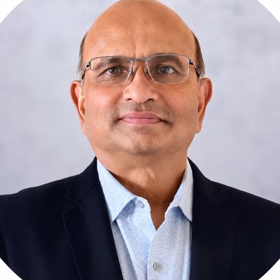Professional portrait of a middle-aged man with glasses.