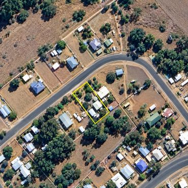 Aerial view of suburban neighborhood with houses and roads.