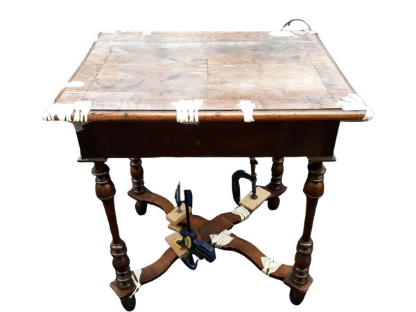 Consolidating veneers on a lath 17th c side table.