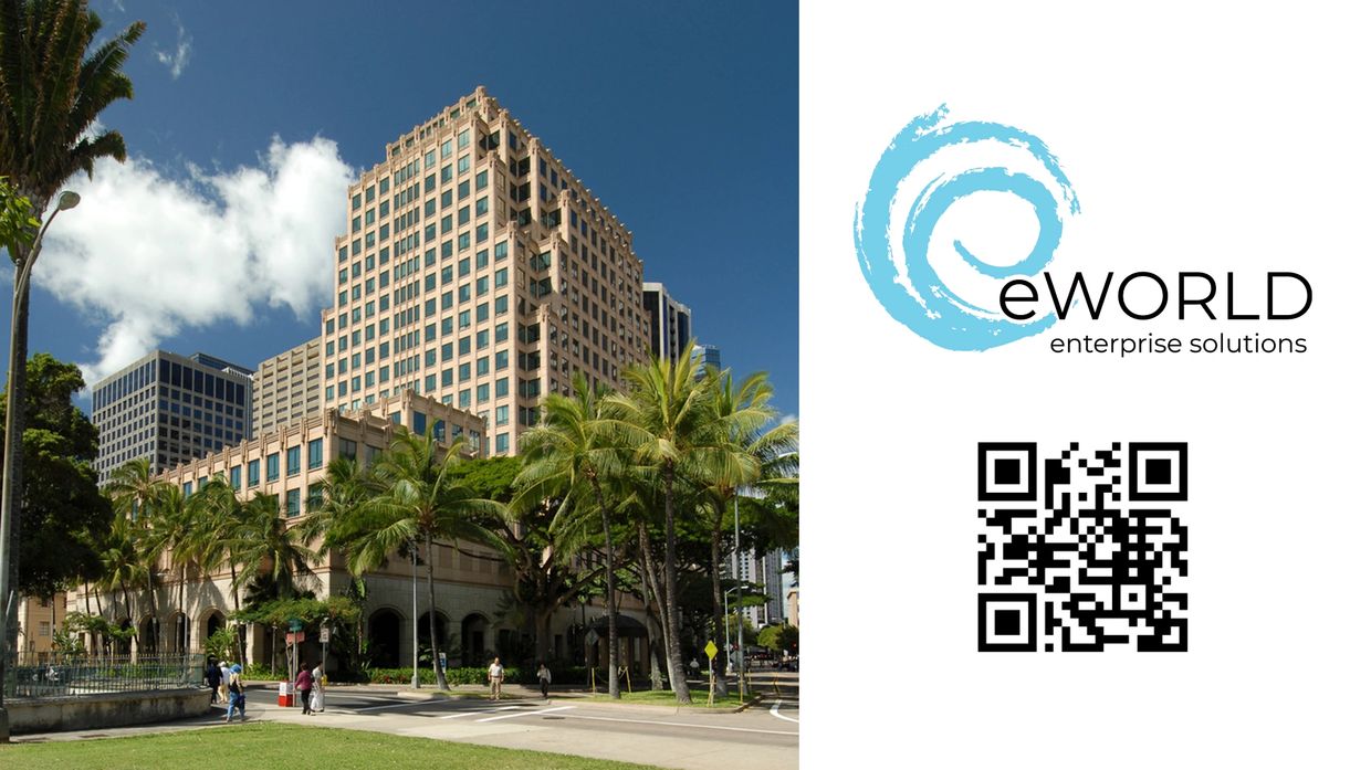 Modern office buildings with palm trees under a blue sky.