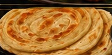 Stack of round flatbreads with a golden crust.