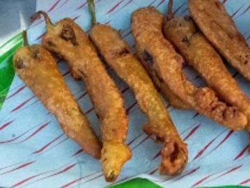 Fried chili peppers on paper.