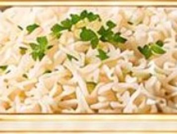 A dish of cooked pasta garnished with fresh herbs.