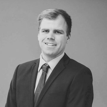 Black and white portrait of a man in a suit.