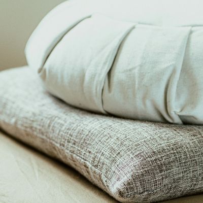 Supportive bolsters providing a restorative foundation for Yoga Nidra and nervous system regulation.