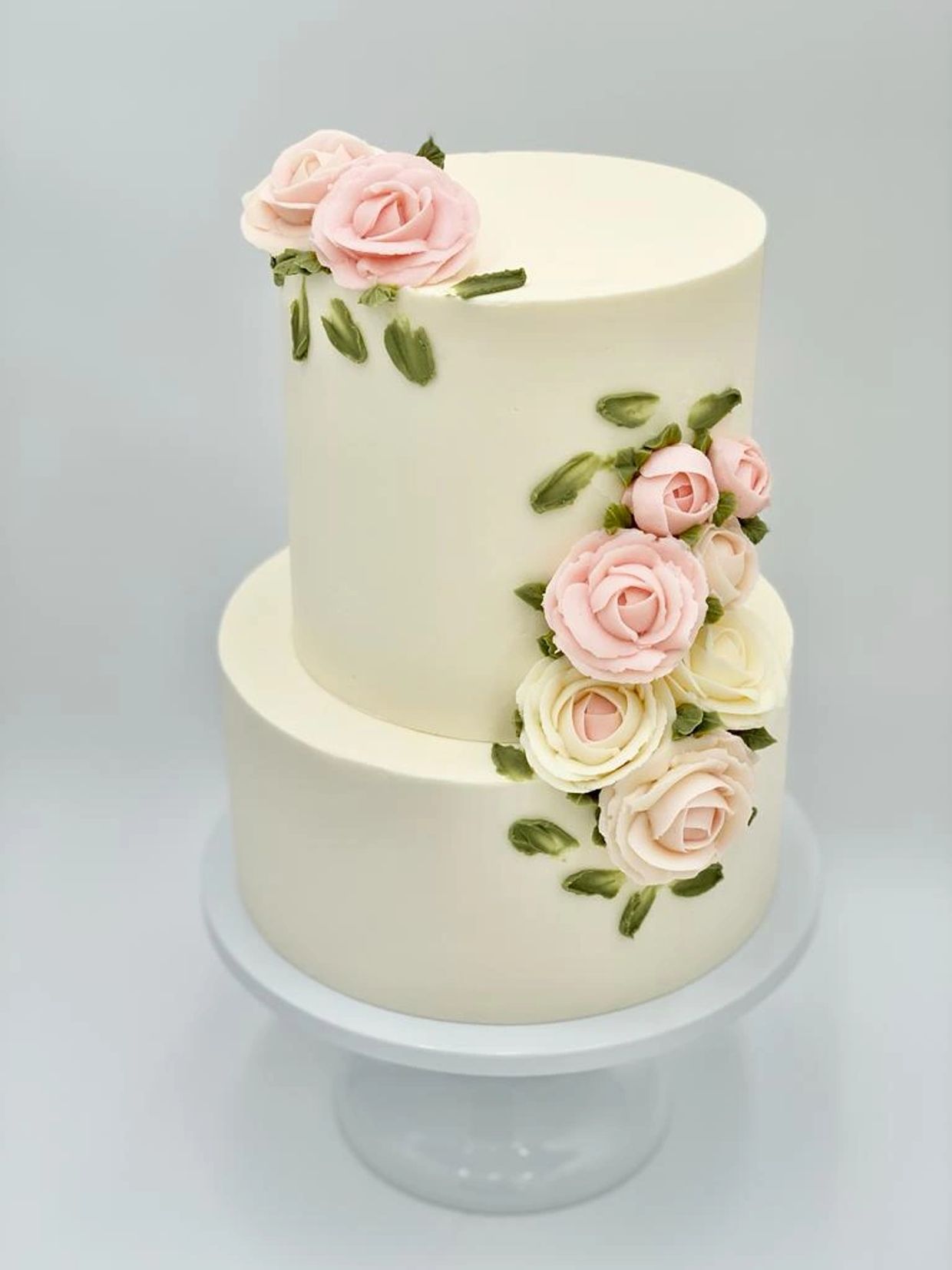 Simple clean and modern wedding cake with buttercream roses