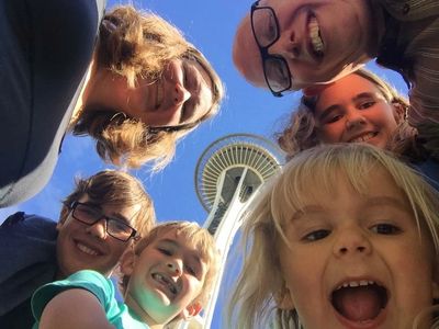 The Guynes family selfie (6 people) with the Seattle space needle in the background.