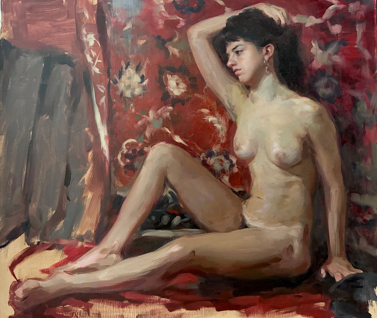 Oil painting of a nude woman seated against a floral red backdrop.
