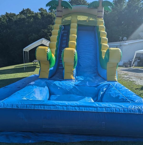 A large inflatable slide in the middle of a yard.