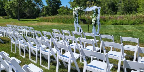 Wedding chairs and arch setup outside