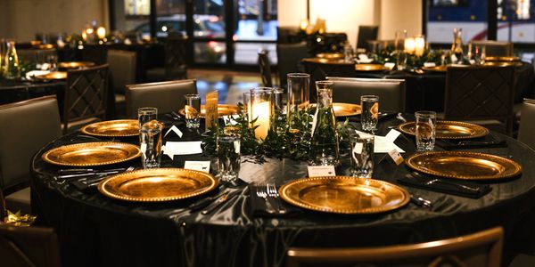 Intimate dinner with black linen and gold plates