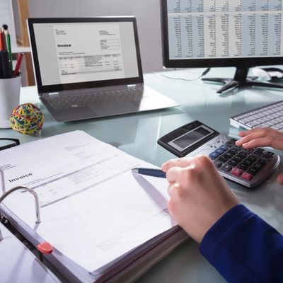 Close-up of a business hand Calculating the invoice at work
