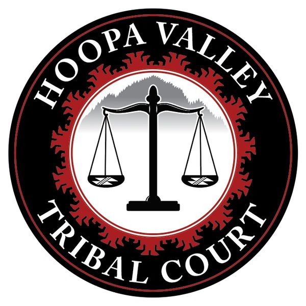 Hoopa Valley Tribal Court logo featuring balanced scales.