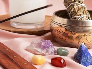 Crystals, sage and a white candle used for healing work.