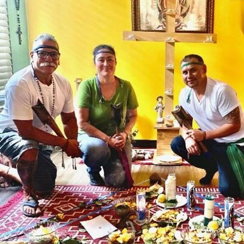Spiritual healers posing for their services over candles and healing work.