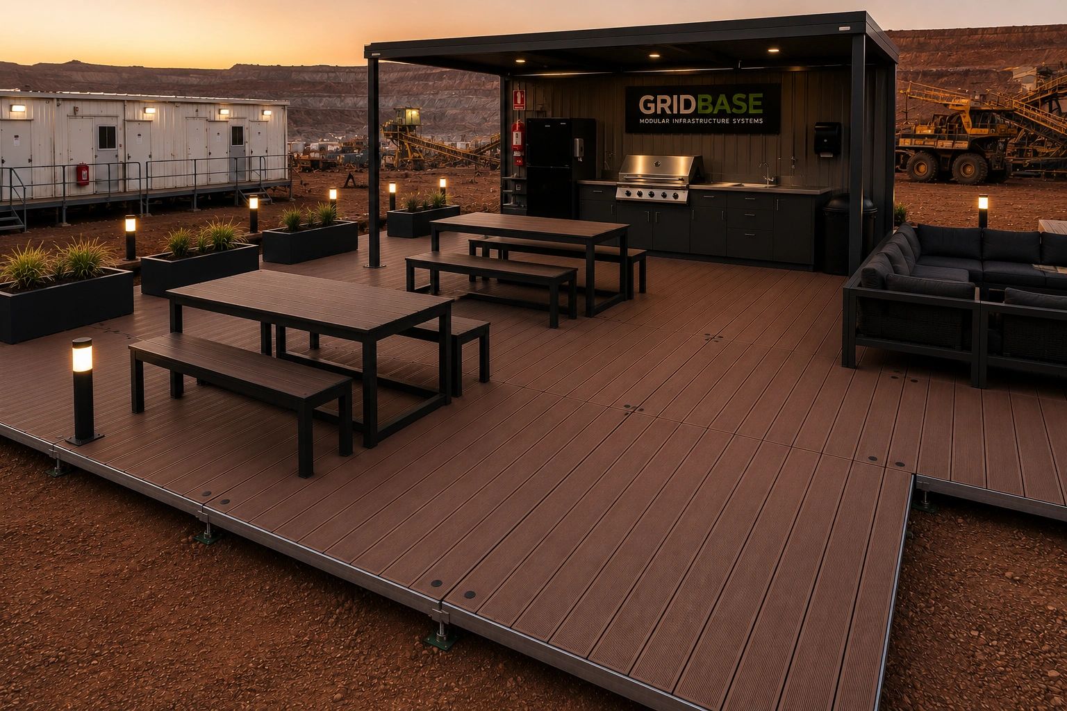 Outdoor modular kitchen and seating area on a raised platform at sunset.
