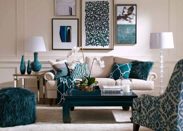Elegant living room with teal accents and abstract wall art.