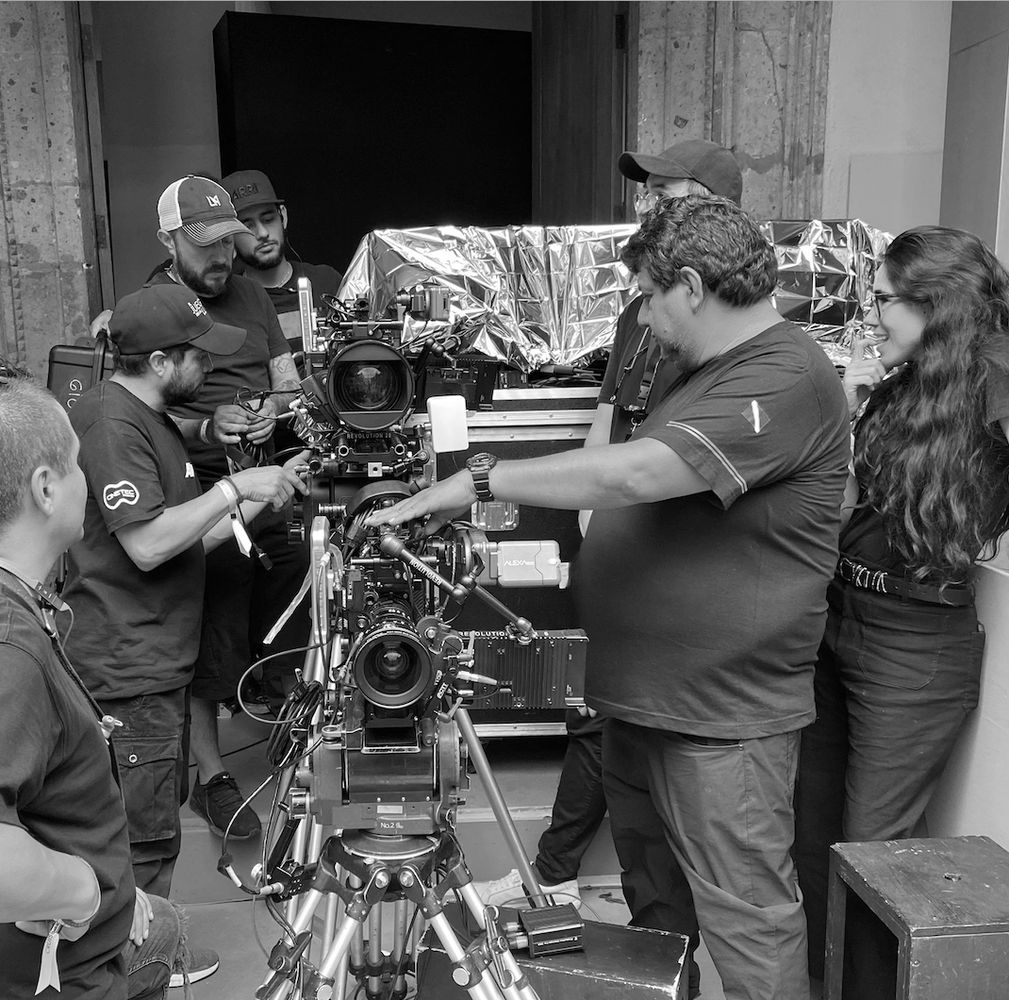 Film crew working with professional cameras on a set.