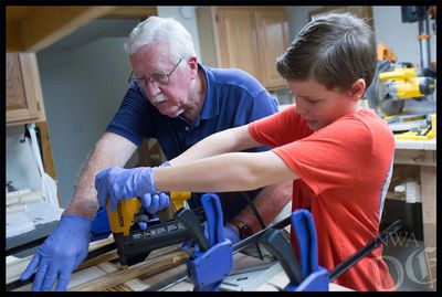 Jeremiah and Don Lowe are gluing a quality wooden flag.  We make the best wooden American flags.