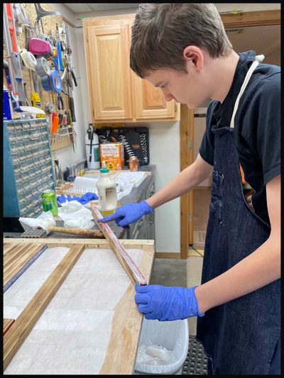 Jeremiah Lowe is gluing flag stripes and the Union together.  We make the best quality flags.