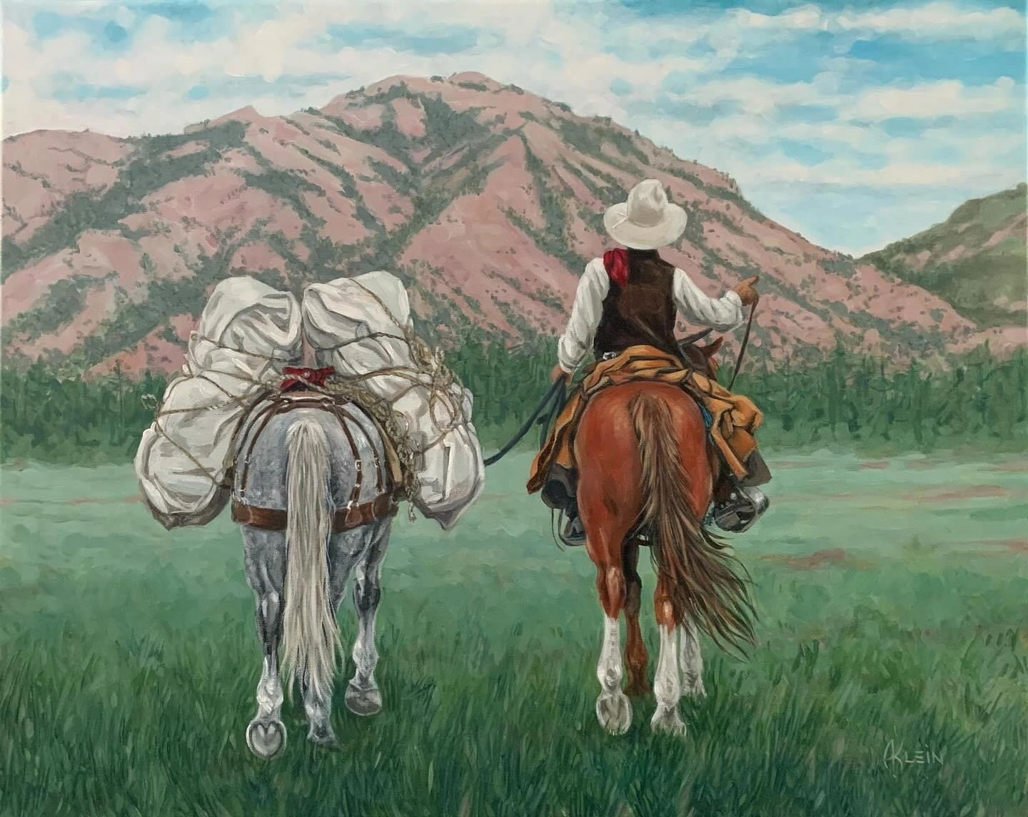 Cowboy riding Horse and leading packhorse
