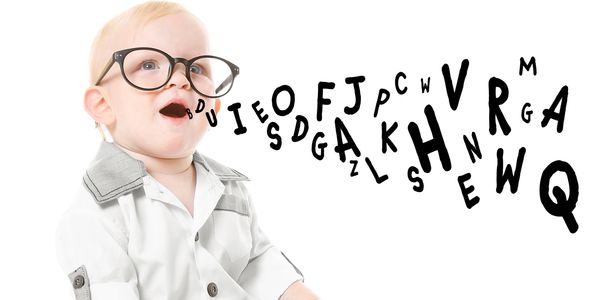 Baby with glasses speaking alphabet letters.