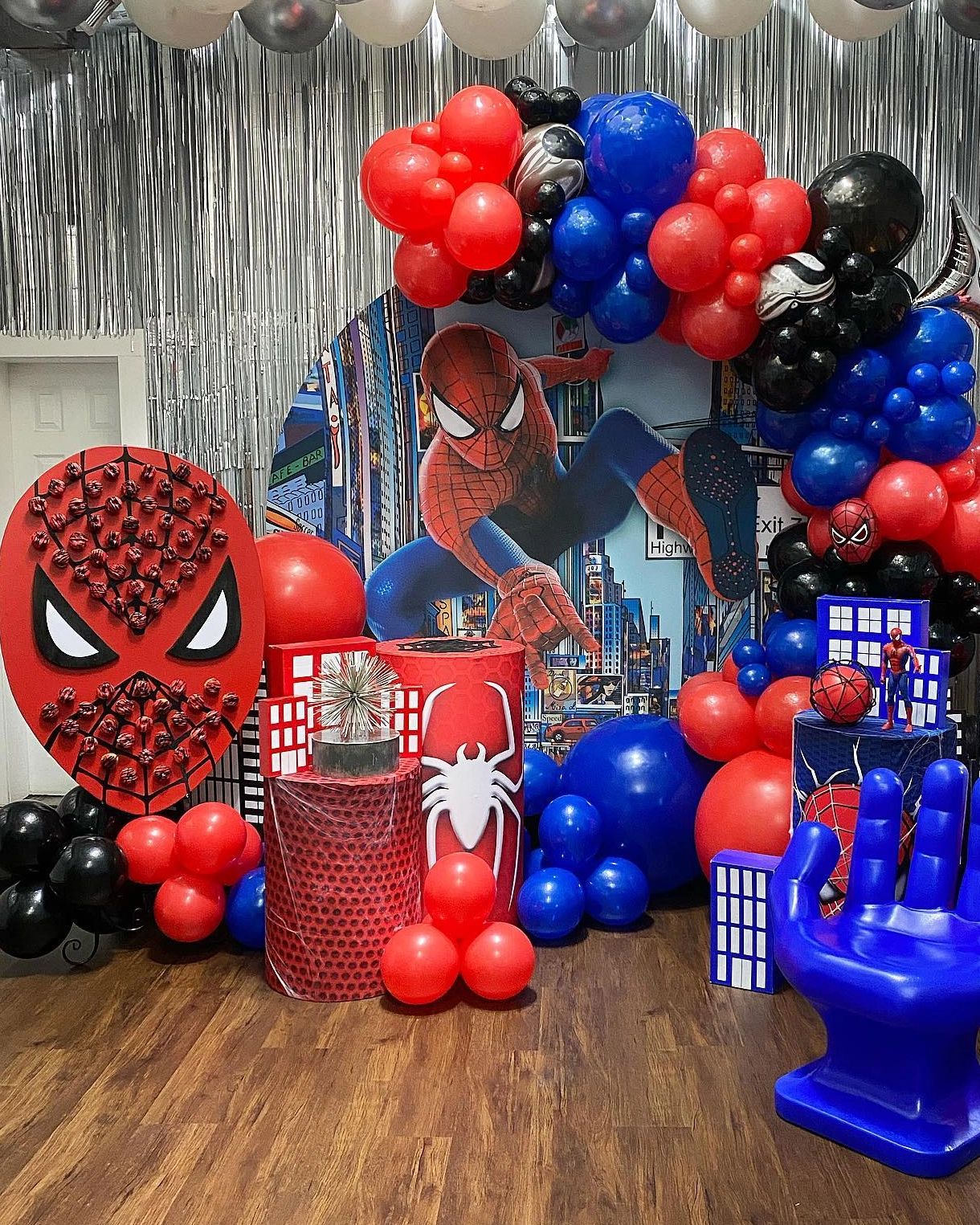 Colorful Spider-Man themed party setup with balloons and decorations.