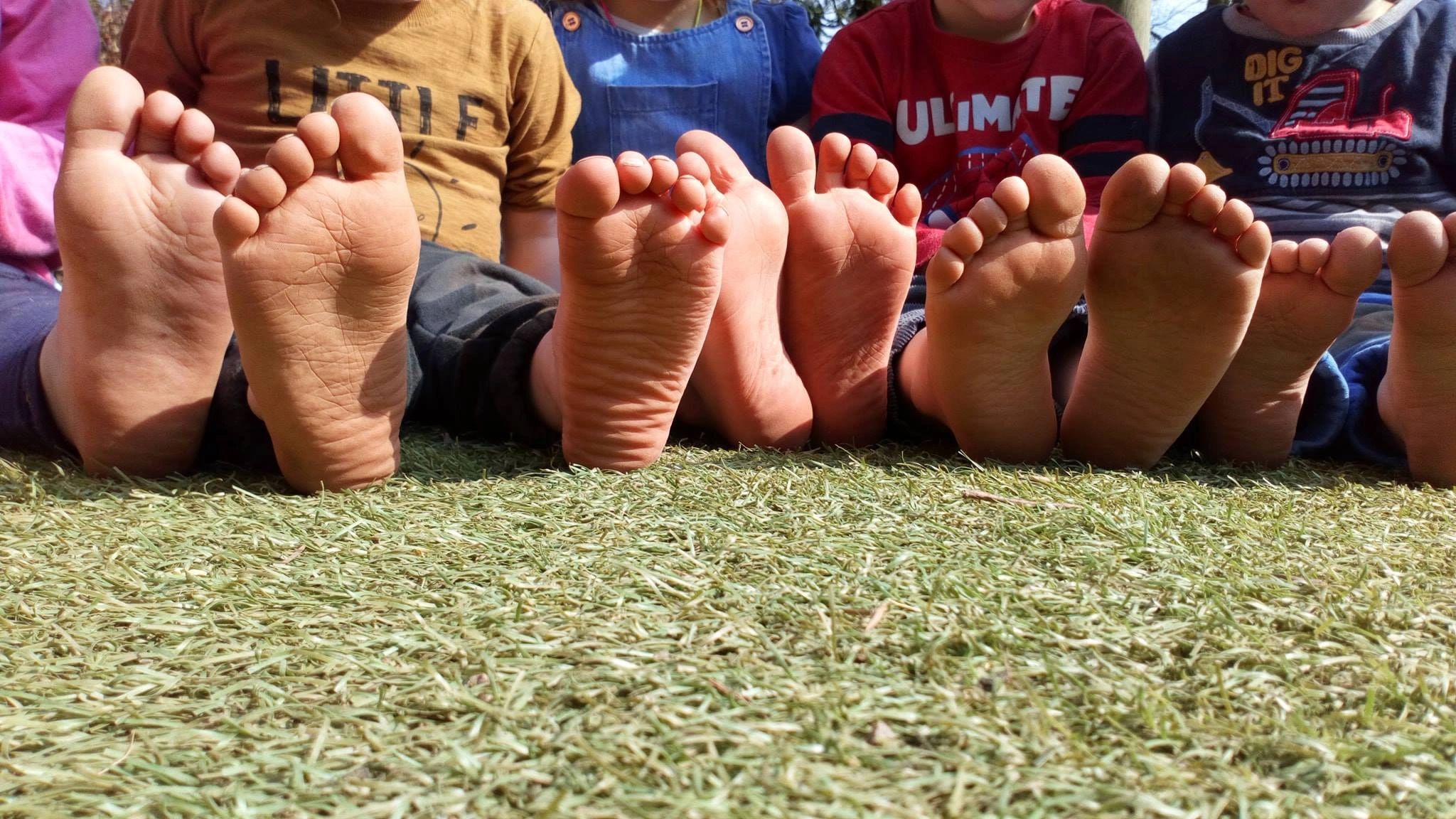 Bare feet- children at Stawley Pre-school, near Wellington enjoying the garden. 