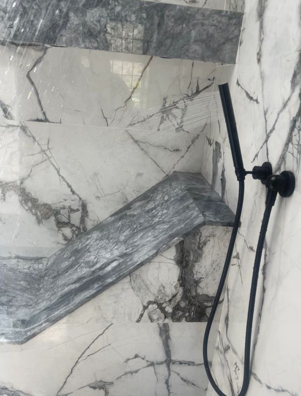 Handheld shower head installed in a new construction home in a beautiful bathroom.