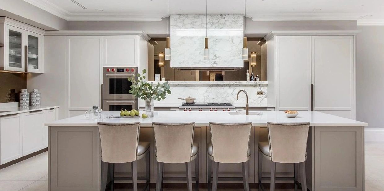 Modern kitchen with marble accents and a large island seating four.