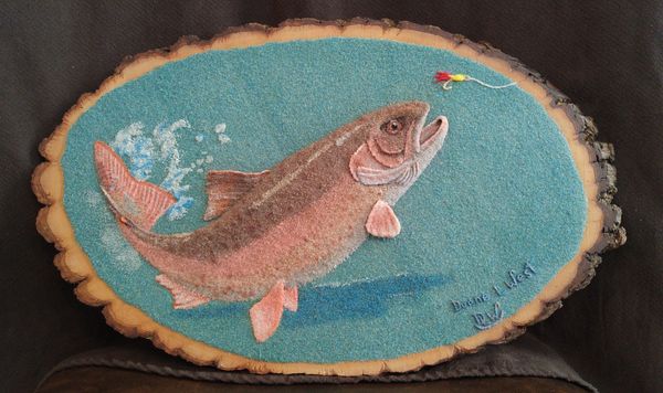 Semi-relief sand sculpture of trout.