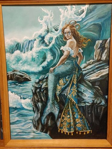 A mermaid clown sits by the crashing waves.