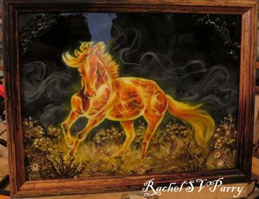 A firehorse running in a dry brush field, in a burnt frame.