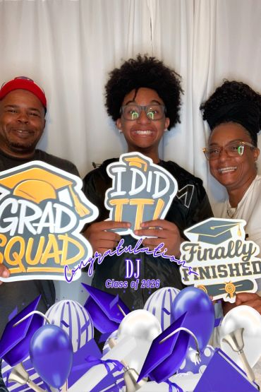 Three people smiling and celebrating a graduation.