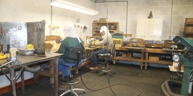 Kiko and Jesus at work in buffing room at World Wide Equine, Glenns Ferry, Idaho, USA