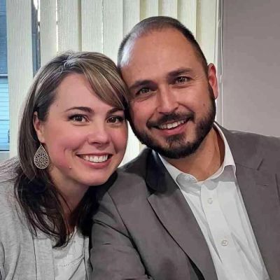 Smiling couple posing closely together indoors.