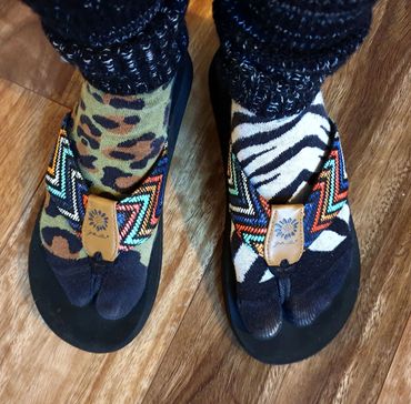 Meli Bee author, writer of children's books, wearing mismatched footwear. Melissa Rae Brett 2021