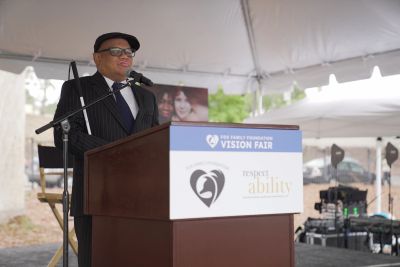 Ollie Cantos delivers the keynote behind a podium at the Fox Family Foundation Vision Fair.