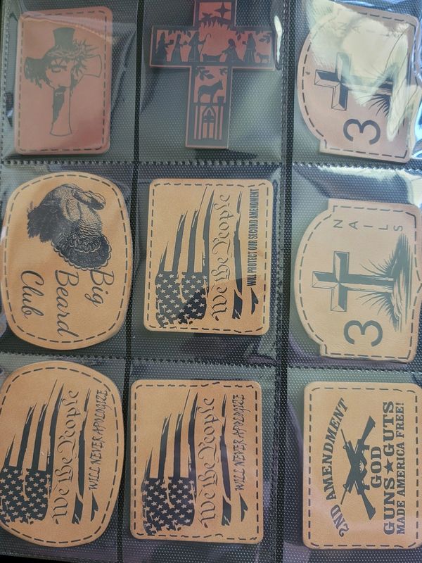 Leather patches with patriotic and religious themes in a plastic sleeve.
