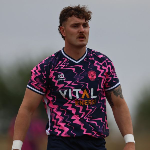 Athlete in a vibrant pink and blue sports jersey.