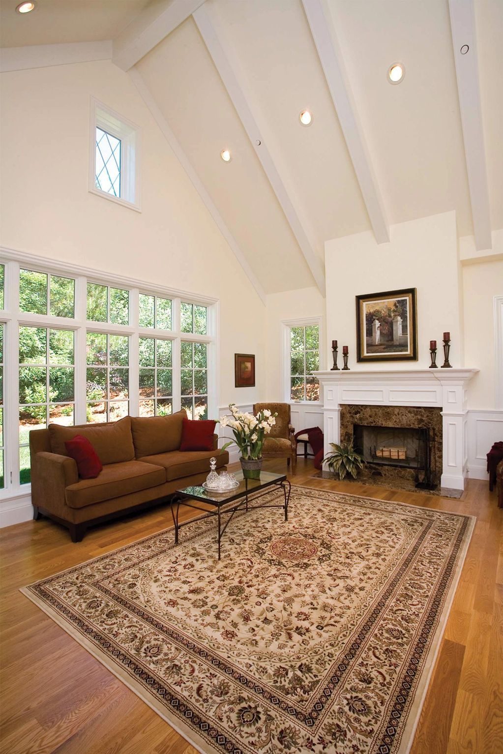 Traditional cathedral vaulted ceiling, recessed lighting, custom leaded glass windows, elegant wains