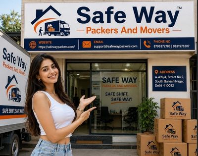 Smiling woman in front of Safe Way Packers and Movers office with boxes.