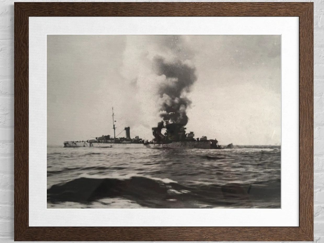 Black and white photo of a warship emitting thick smoke on the sea.