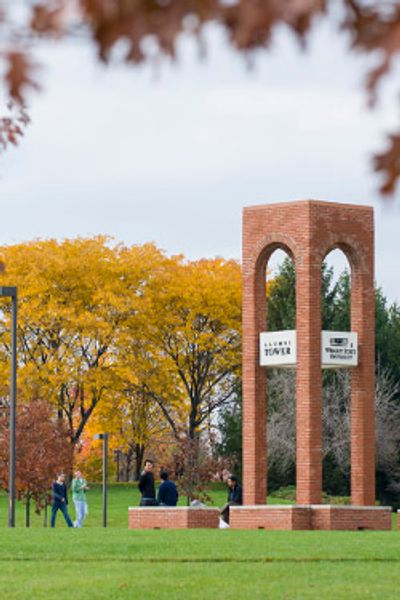 Alumni Tower on a college campus in autumn.