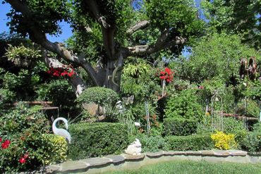 beautiful backyard garden with animal sculptures and flowering plants